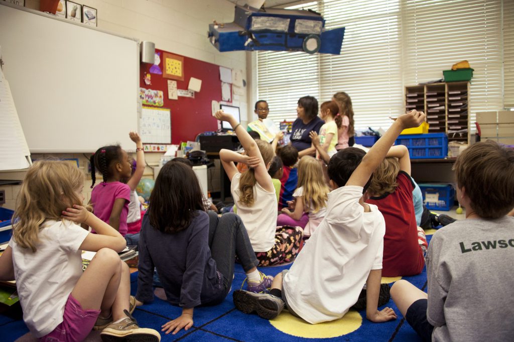 School-age provider/teacher working with group of school-age children